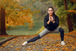 Girl doing stretching exercises in the park