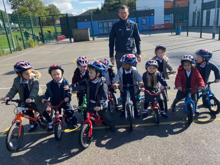 British Cycling coach Simon Wilson with reception pupils at Silver Springs Primary Academy in Stalybridge