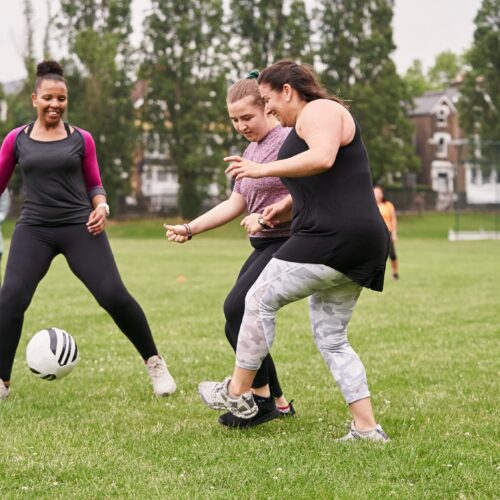 women playing football