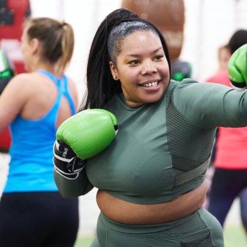 woman punching pads at a box fit class