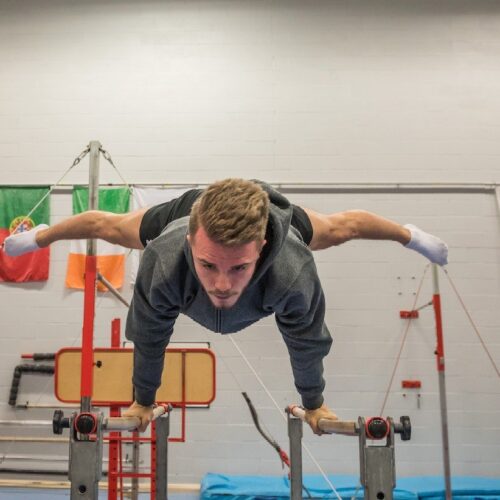 man on parallel bars