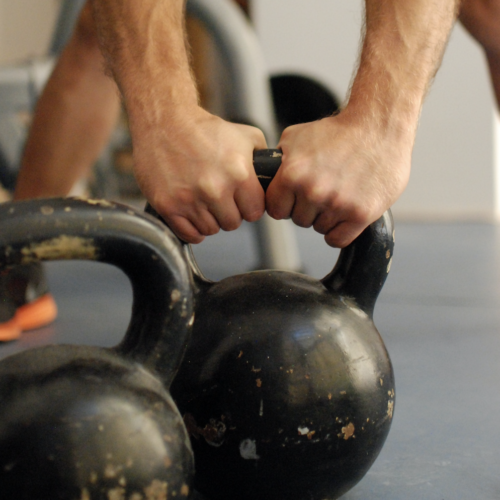 person lifting a kettlebell