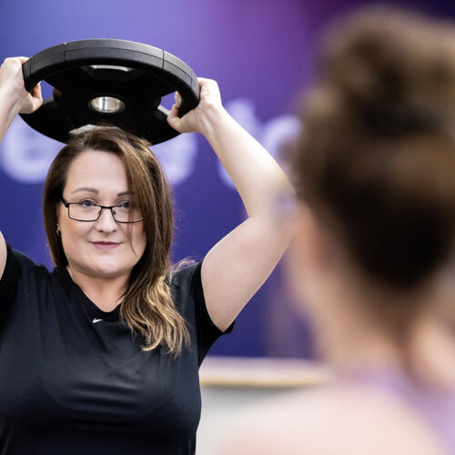 Woman lifts weight above her head