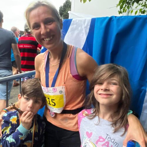 Abi posing with her children for a photograph after a running event