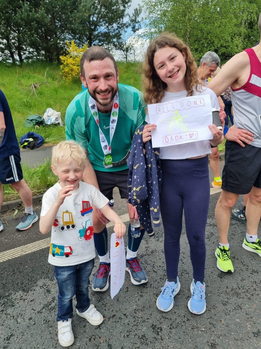 Photo of Stephen with his children after a running event